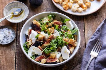 Fig and mozzarella salad with croutons and rocket leaves