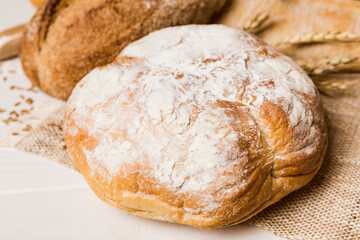 Homemade natural breads. Different kinds of fresh bread as background, perspective view with copy space