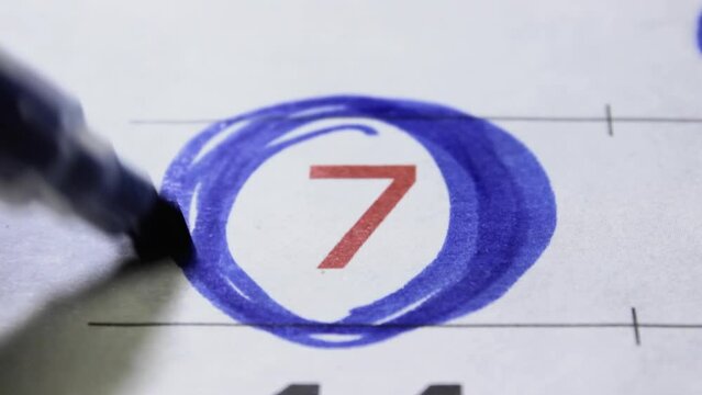 Holiday date the seventh number in calendar is circled with a blue marker close-up