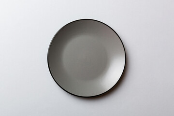 Top view of isolated of colored background empty round gray plate for food. Empty dish with space for your design