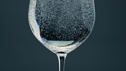 Air bubbles rising cup surface closeup. Pure refreshing water in transparent