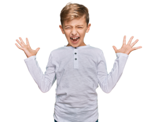 Little caucasian boy kid wearing casual clothes celebrating mad and crazy for success with arms raised and closed eyes screaming excited. winner concept