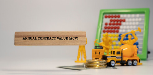 Annual contract value, ACV, written on wooden surface. Economy and markets.