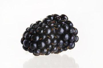 Close-up. One fresh blackberry. Isolated on a white background. Minimalism. There are no people in the photo. Sweet light dessert, juices, jams, toppings for cakes, pastries.