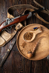 Smoking Pipe and corsair weapons on the wooden table