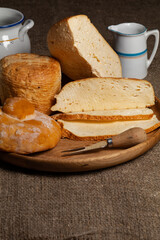 homemade wheels of cheese on wooden table.