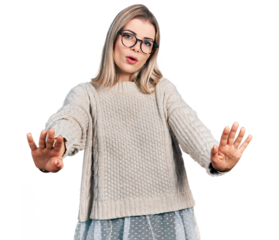 Young blonde woman wearing glasses doing stop gesture with hands palms, angry and frustration expression