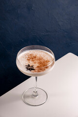 Homemade Eggnog with cinnamon and nutmeg in martini glass.