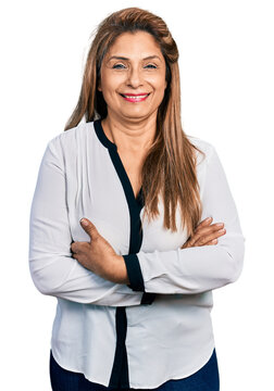 Middle age latin woman wearing business shirt happy face smiling with crossed arms looking at the camera. positive person.