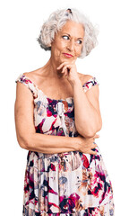 Senior grey-haired woman wearing casual clothes with hand on chin thinking about question, pensive expression. smiling with thoughtful face. doubt concept.