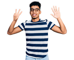 Fototapeta premium Young african american man wearing casual clothes and glasses showing and pointing up with fingers number eight while smiling confident and happy.