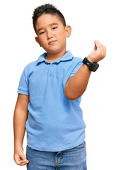 Little boy hispanic kid wearing casual clothes doing italian gesture with hand and fingers confident expression