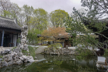 Fototapeta na wymiar Staten Island, New York: Pond in the New York Chinese Scholars Garden, a walled garden built in 1998 at the Snug Harbor Cultural Center and Botanical Garden.