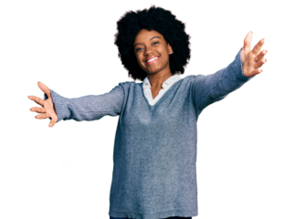 Young african american woman wearing business clothes looking at the camera smiling with open arms for hug. cheerful expression embracing happiness.