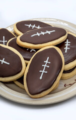 Football shape cookies on plate. Home made cookies concept. American sport concept. Super Bowl party cookies.