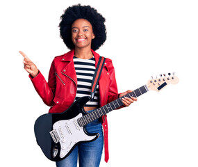 Young african american woman playing electric guitar smiling happy pointing with hand and finger to...