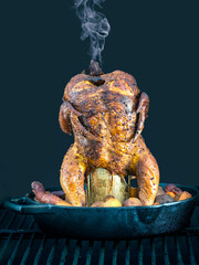 Smoke exiting from the top of a beer can chicken - 539874293
