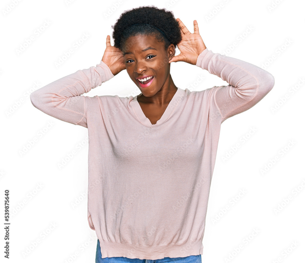 Poster Young african american girl wearing casual clothes smiling cheerful playing peek a boo with hands showing face. surprised and exited