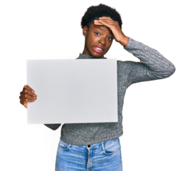 Young african american girl holding blank empty banner stressed and frustrated with hand on head, surprised and angry face
