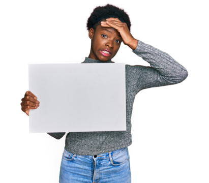 Young african american girl holding blank empty banner stressed and frustrated with hand on head, surprised and angry face