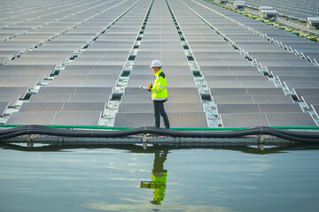 Portrait of professional man engineer working checking the panels at solar energy on buoy floating....