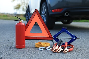 Emergency warning triangle and car safety equipment outdoors