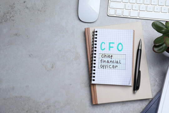 Notebook With CFO Abbreviation And Space For Text On Grey Office Table, Flat Lay. Financial Management