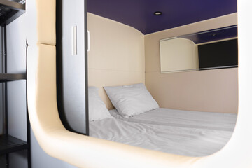 Capsule with twin bed in modern pod hostel. Stylish interior