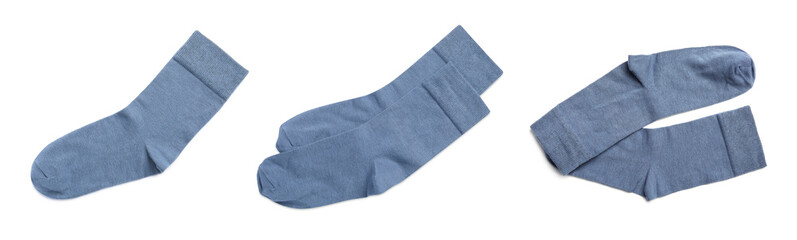 Set with pairs of blue socks on white background, top view. Banner design