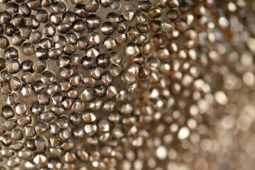 Wallpaper metallic granular phone.Shiny grainy texture.Beautiful background in bronze tones.wall texture