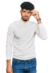 Fototapeta premium Young arab man wearing casual winter sweater worried and stressed about a problem with hand on forehead, nervous and anxious for crisis