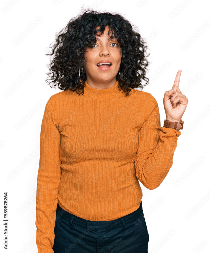 Poster Young hispanic woman wearing casual clothes pointing finger up with successful idea. exited and happy. number one.