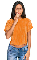 Young brunette arab woman wearing casual clothes touching mouth with hand with painful expression...
