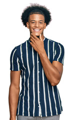 African american man with afro hair wearing casual clothes looking confident at the camera smiling with crossed arms and hand raised on chin. thinking positive.