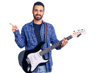 Young hispanic man playing electric guitar smiling happy pointing with hand and finger to the side