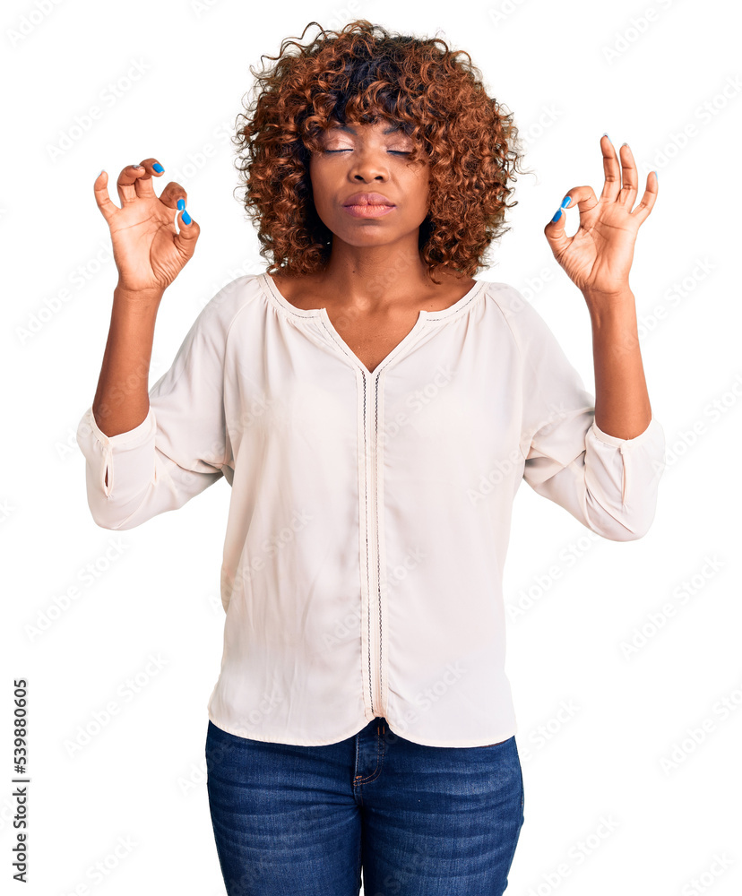 Wall mural Young african american woman wearing casual clothes relax and smiling with eyes closed doing meditation gesture with fingers. yoga concept.