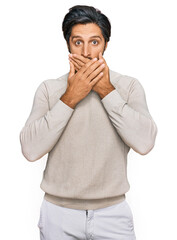 Young hispanic man wearing casual clothes shocked covering mouth with hands for mistake. secret concept.