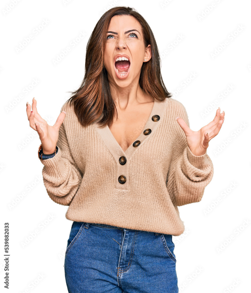 Sticker young brunette woman wearing casual winter sweater crazy and mad shouting and yelling with aggressiv