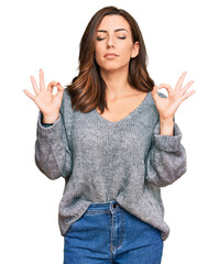 Young brunette woman wearing casual winter sweater relax and smiling with eyes closed doing meditation gesture with fingers. yoga concept.