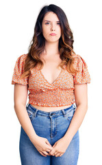 Beautiful young brunette woman wearing casual clothes depressed and worry for distress, crying angry and afraid. sad expression.