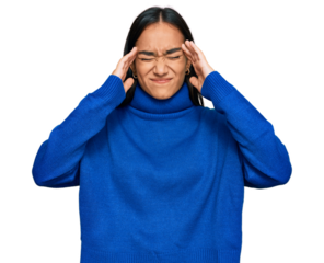 Young asian woman wearing casual winter sweater suffering from headache desperate and stressed because pain and migraine. hands on head.