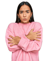 Young asian woman wearing casual winter sweater shaking and freezing for winter cold with sad and...