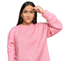 Young asian woman wearing casual winter sweater pointing unhappy to pimple on forehead, ugly infection of blackhead. acne and skin problem