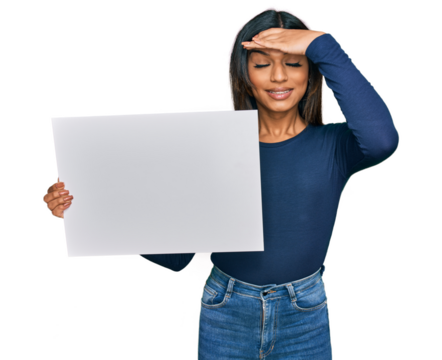 Young latin transsexual transgender woman holding blank empty banner stressed and frustrated with hand on head, surprised and angry face