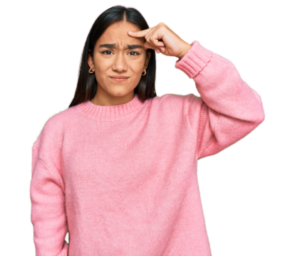 Young asian woman wearing casual winter sweater pointing unhappy to pimple on forehead, ugly infection of blackhead. acne and skin problem