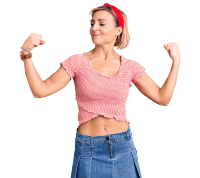 Young blonde woman wearing casual clothes and diadem showing arms muscles smiling proud. fitness concept. - Powered by Adobe
