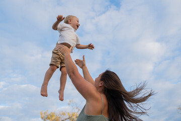 lesbian mother throwing child into air