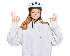 Beautiful young caucasian girl wearing bike helmet relax and smiling with eyes closed doing meditation gesture with fingers. yoga concept.