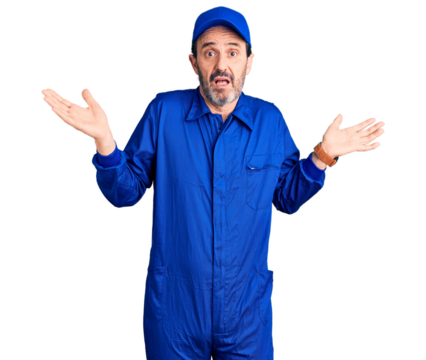 Middle age handsome man wearing mechanic uniform clueless and confused expression with arms and hands raised. doubt concept.