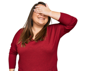 Beautiful brunette plus size woman wearing casual clothes smiling and laughing with hand on face covering eyes for surprise. blind concept.